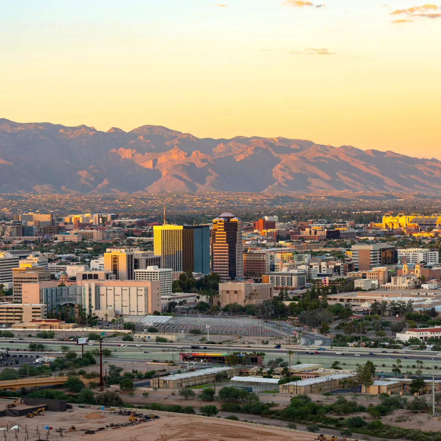 an aerial view of a city with mountains in the background