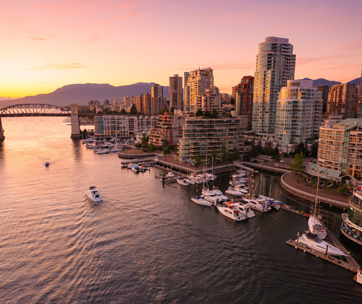 boats are docked in a harbor with a city in the background