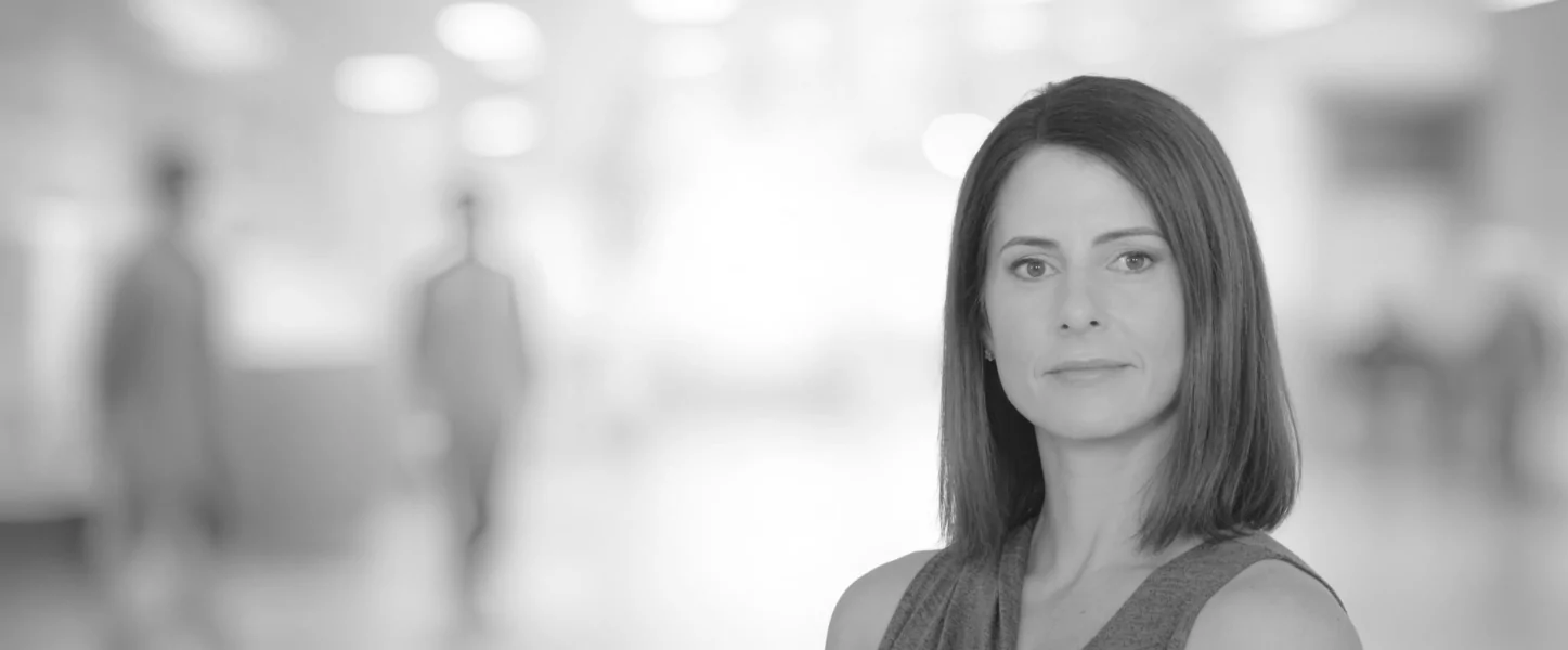 a black and white photo of a woman looking at the camera