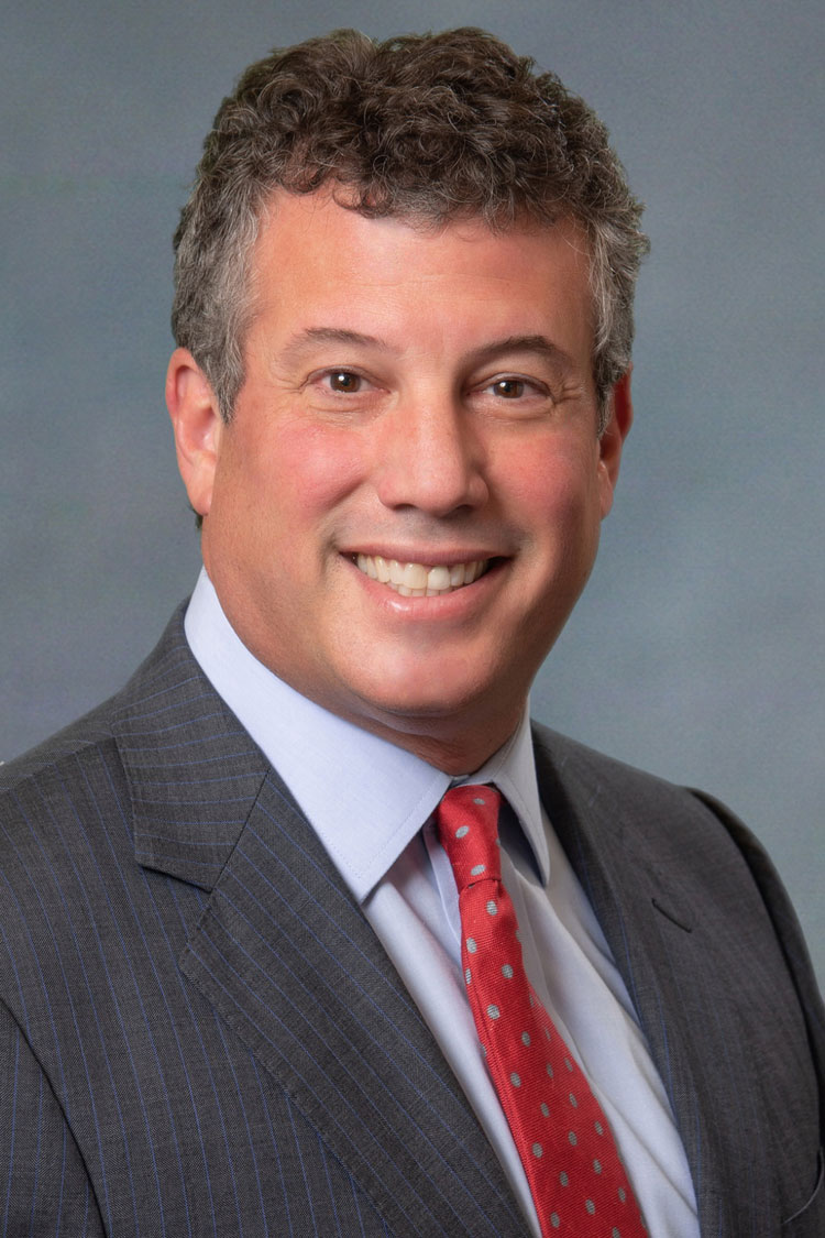 a man in a suit and tie smiles for the camera