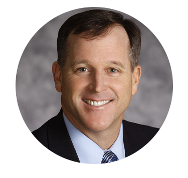 a man in a suit and tie smiles for the camera