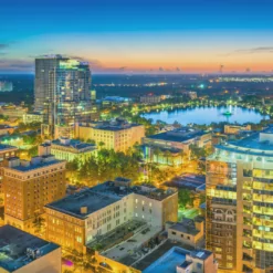 an aerial view of a city with a lake in the background