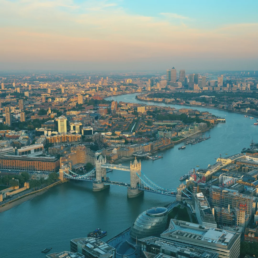 an aerial view of the city of london with the tower bridge in the foreground